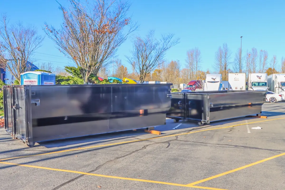 Professional dumpster rental service with roll-off container on residential driveway in Miramar